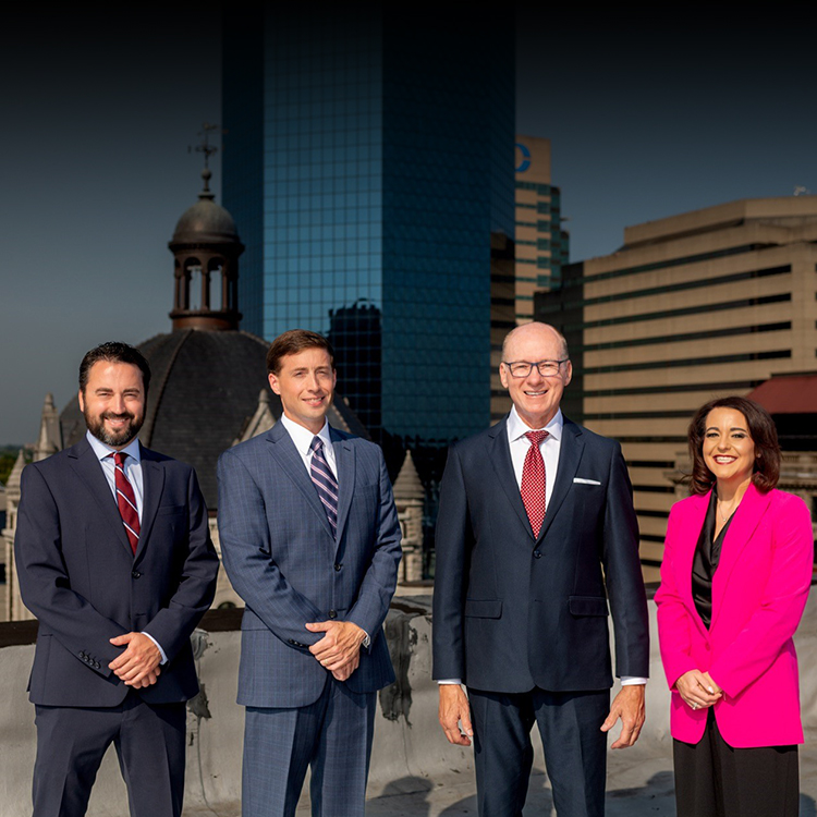 Group photo of the Mehr Fairbanks Trial Lawyers and the Lexington skyline in the background